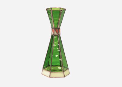 A green and beige geometric stained glass vase.