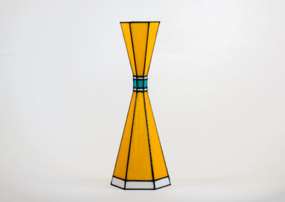 A modern yellow stained glass lamp with blue accents.