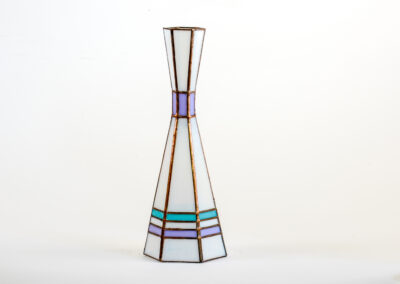 A tall, slender vase with geometric stained glass design.