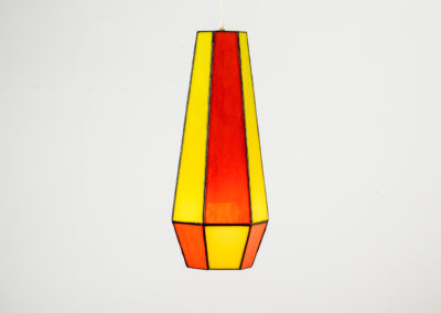Tall geometric vase with orange and yellow panels.