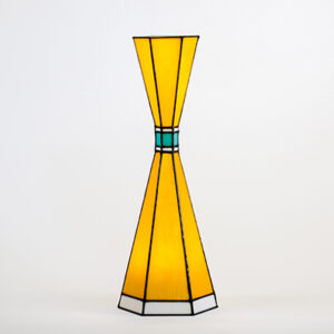 A yellow stained glass vase with blue accents.