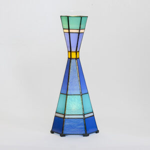 A tall, colorful stained glass vase with a geometric design.