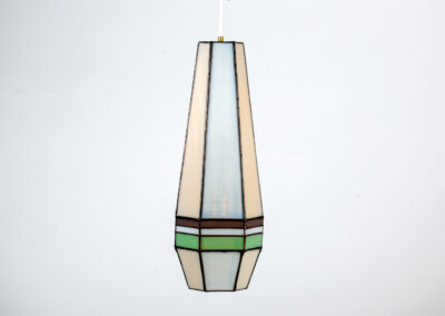 A tall, geometric pendant lamp with pastel-colored accents.