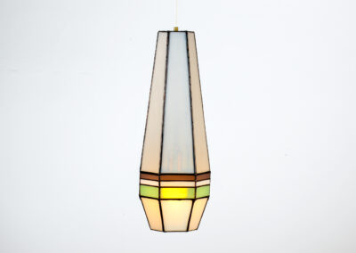 A vintage pendant lamp with geometric stained glass design.