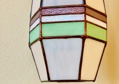Close-up of a stained glass lamp shade with pastel colors.