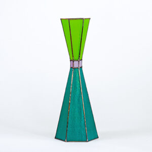 A colorful, geometrically shaped vase with green and teal sections.