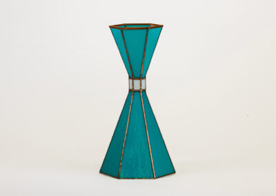 A teal hourglass-shaped decorative vase with gold accents.