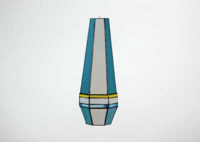 A modern geometric hanging pendant lamp with blue, gray, and yellow accents.