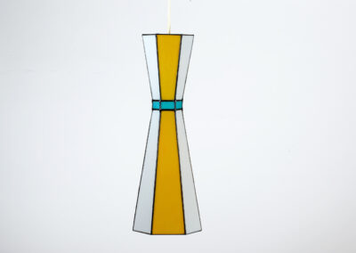 A modern glass vase with yellow and blue accents.